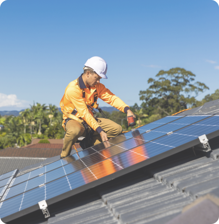 man installing residential solar panels on rooftop