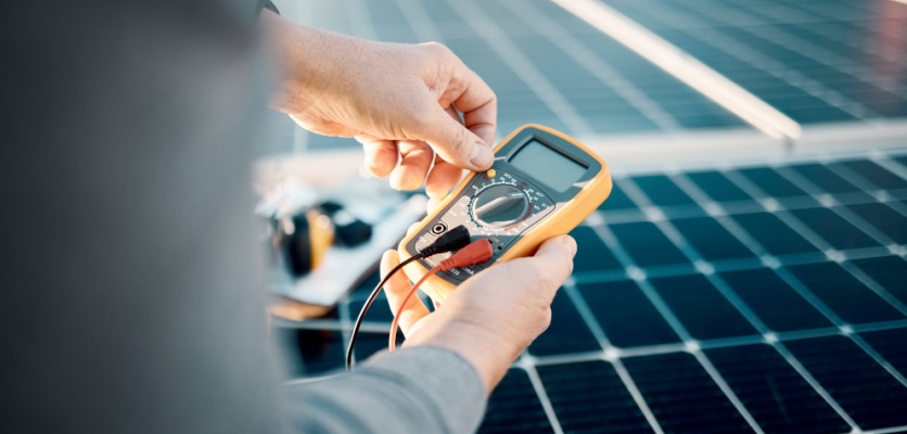 solar panel technician performing maintenance