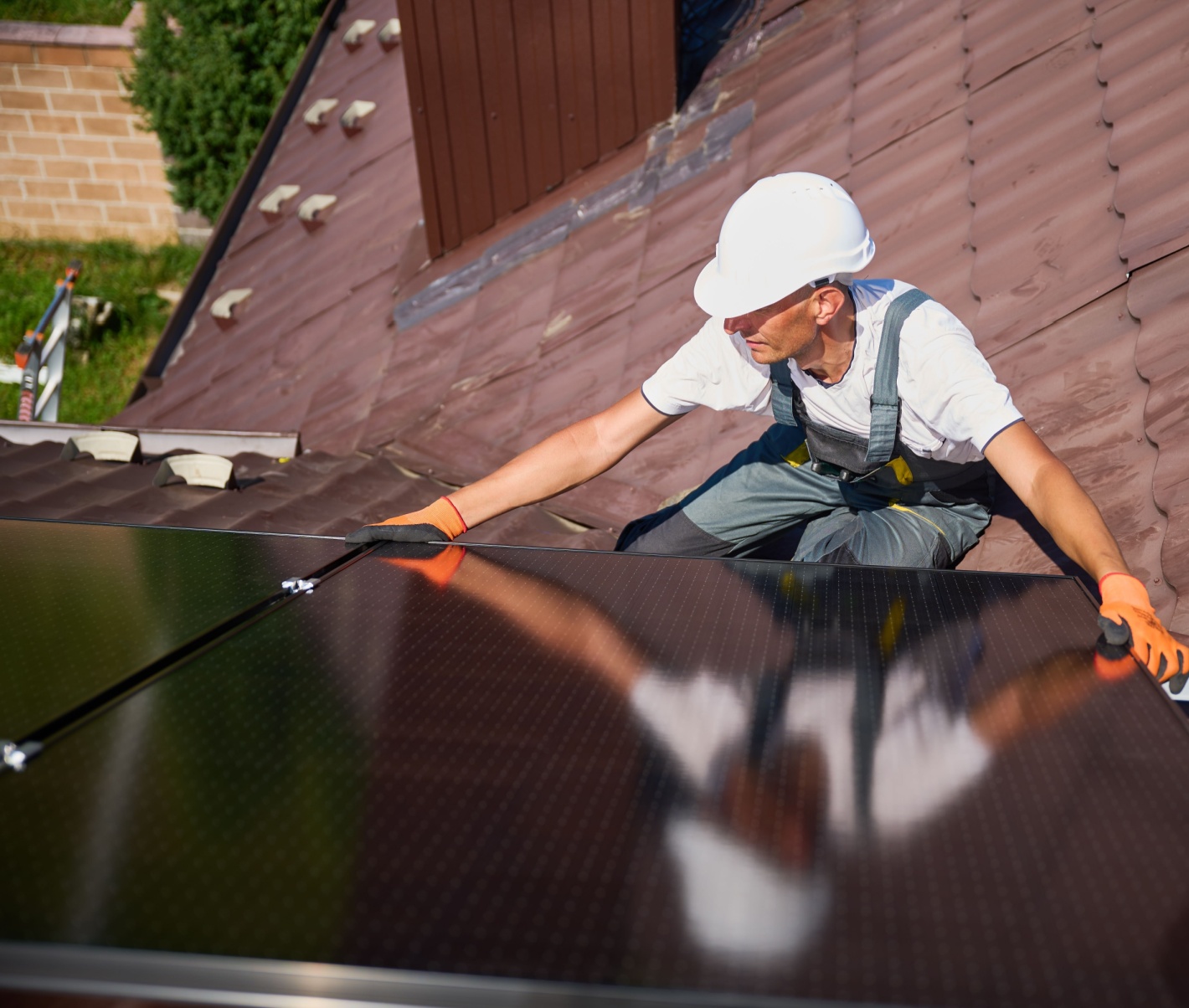 man installing solar panels on a rooftop
