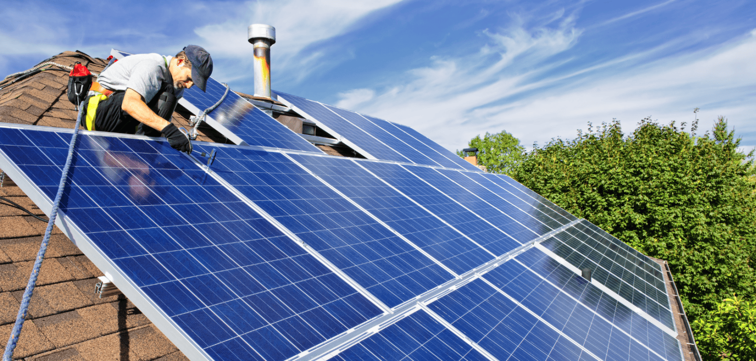 future solar technician installing solar panels on roof